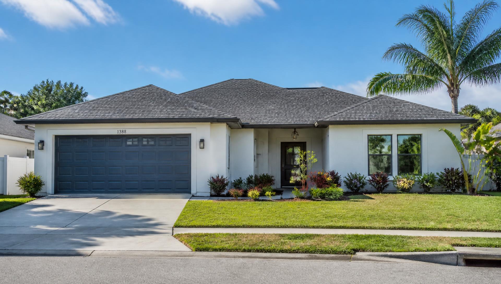 Florida single-family home with a new roof and modern impact windows on a bright day